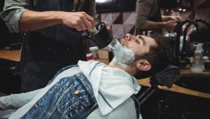 mid-section-barber-applying-cream-clients-beard-2048x1367-2.jpg